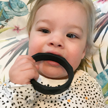 Load image into Gallery viewer, Picture of baby with black teething bangle. Ideal for teething babies.

